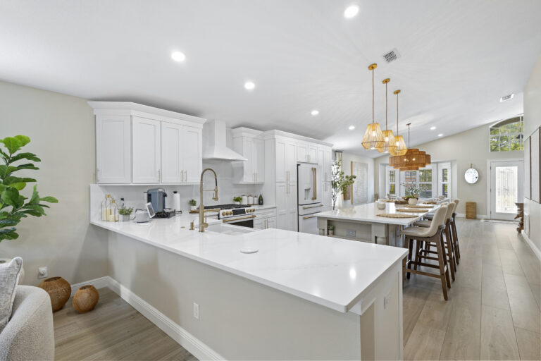 White shaker cabinets with quartz countertops installed in a Lake Mary FL kitchen remodel by Complete Remodel LLC